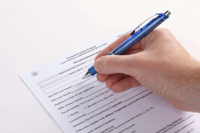 a man filling the loan form with blue pen