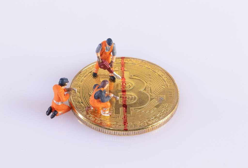 3 man cutting bitcoin 